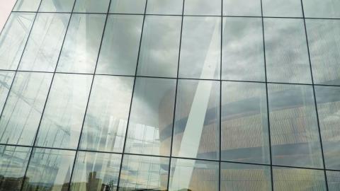 Study visits during Europe, let's cooperate! on 15 March 2023 will take you to interesting sites around Stockholm Glass wall of a building with a reflection of clouds