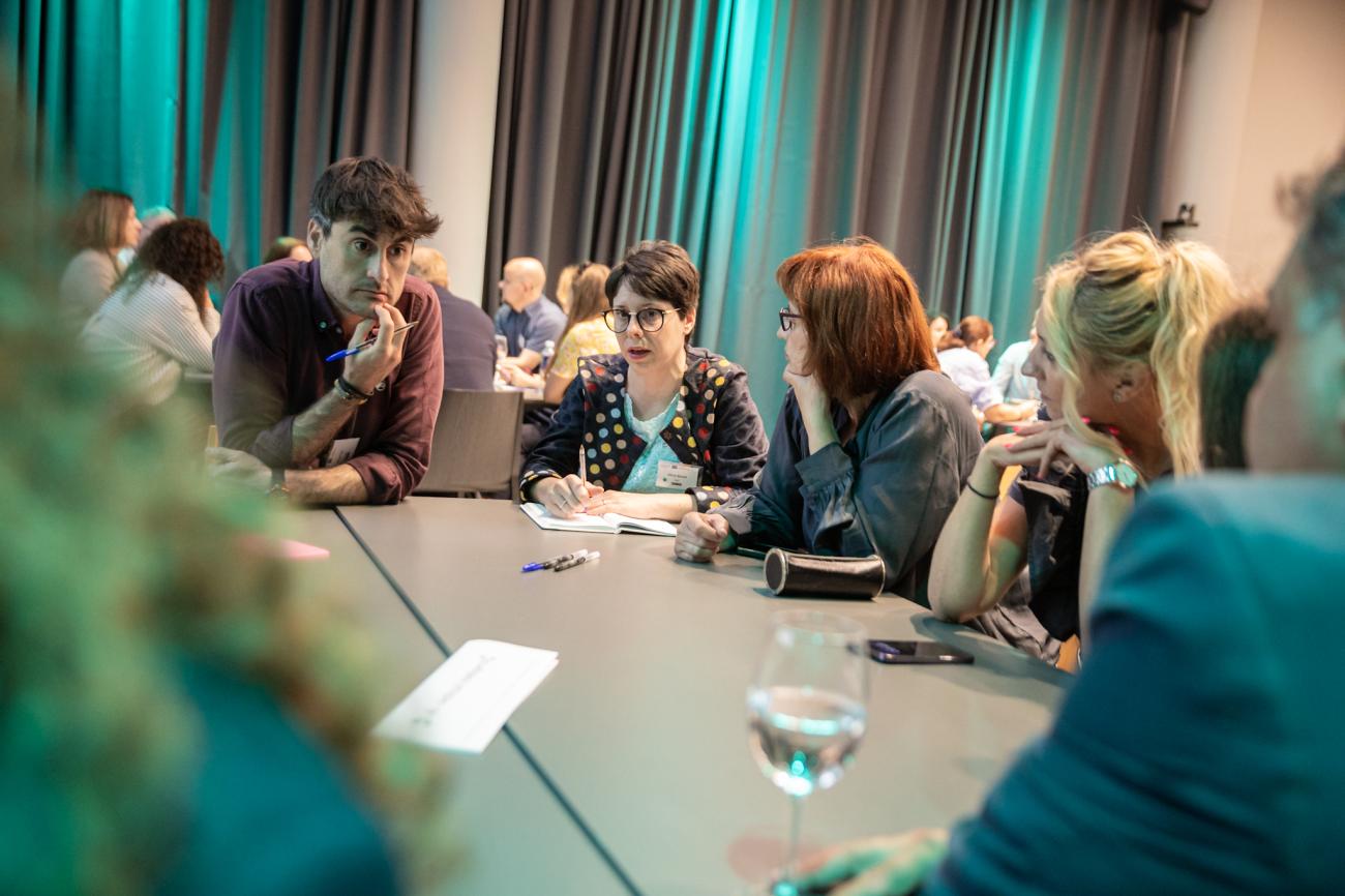 six people talking around a table six people talking around a table