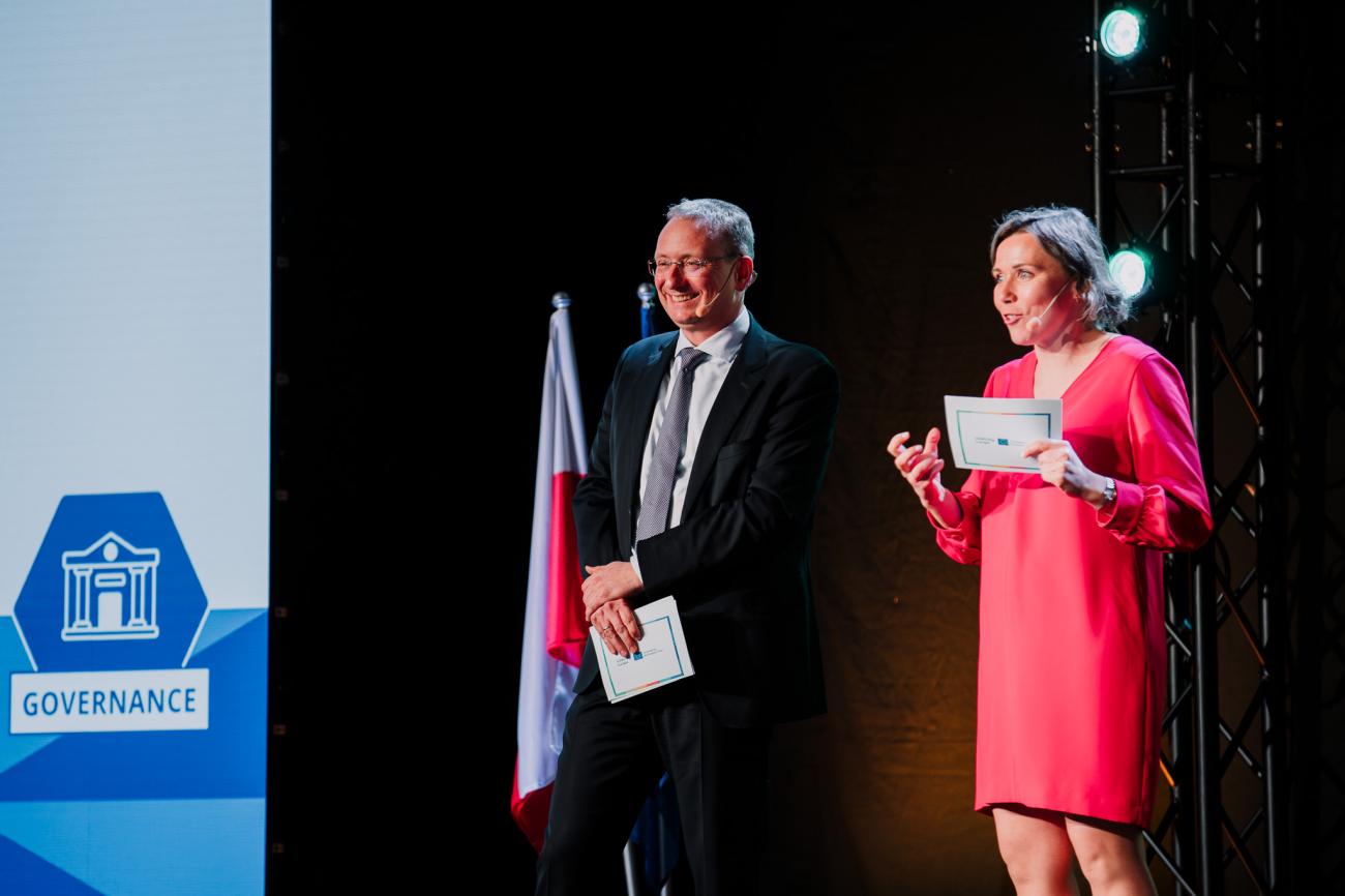 Two moderators present on stage at Europe, let's cooperate! 2025