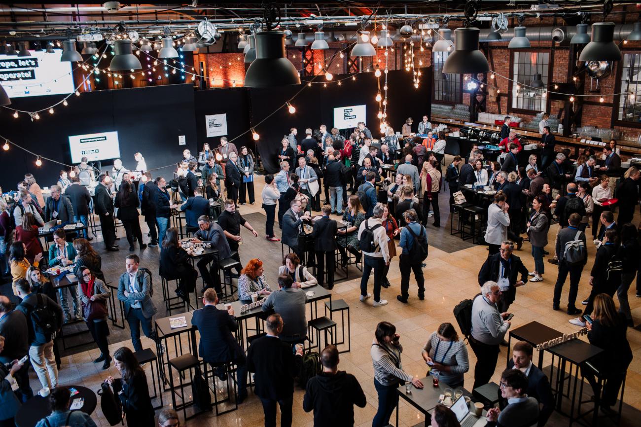 Wide shot of the main hall in the venu with people networking at Europe, let's cooperate! 2025