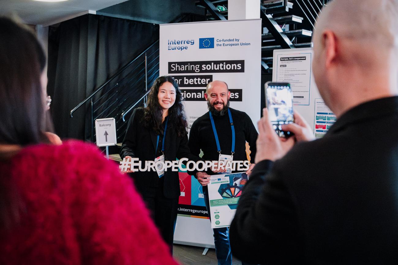 People take photo in front of Interreg Europe branding at Europe, let's cooperate! 2025