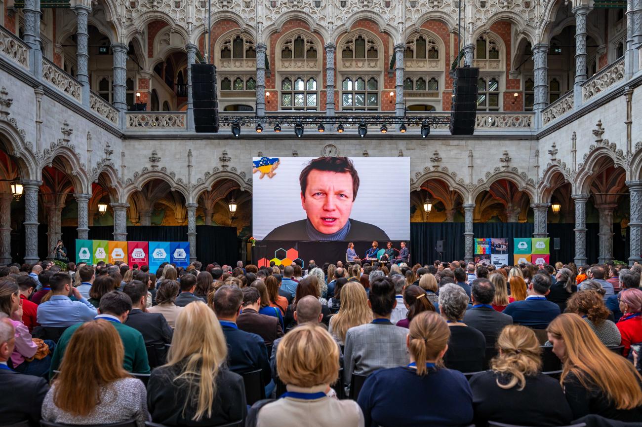 Speaker from Ukraine on large screen at Europe, let's cooperate 2024