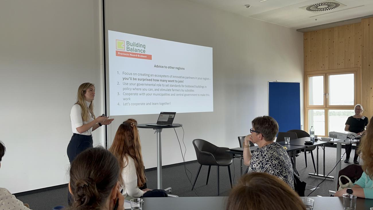 Woman presenting in front of a group of people 