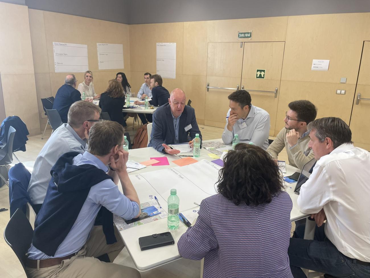 People working and speaking around table by group 