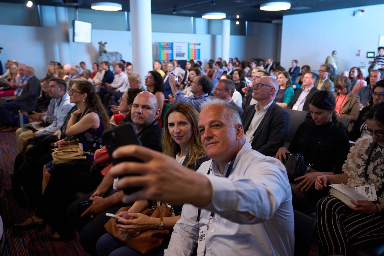 People taking a selfie in a conference hall