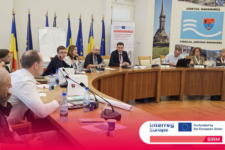 4th Transnational Learning Meeting - Maramureș (Romania) Meeting participants in conversation, seated at a round table.