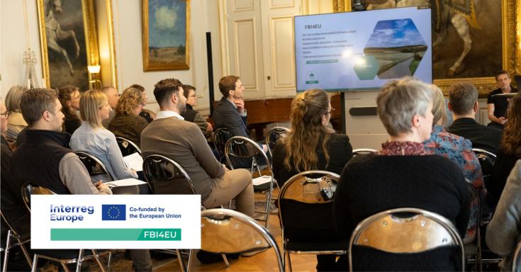 Stakeholder Meeting in Sweden – FBI4EU Project Session Participants attending a stakeholder meeting in Sweden as part of the FBI4EU project, seated in a historical room with large paintings and a presentation screen displaying project information.