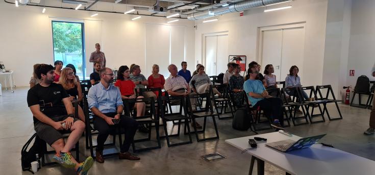 Stakeholders meeting people staying on chairs participating to an event