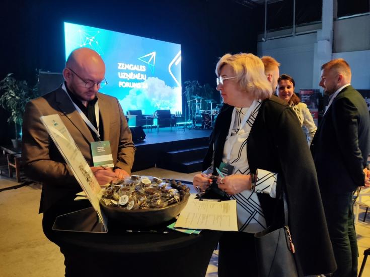 Forum participants standing by the InterRevita project stand
