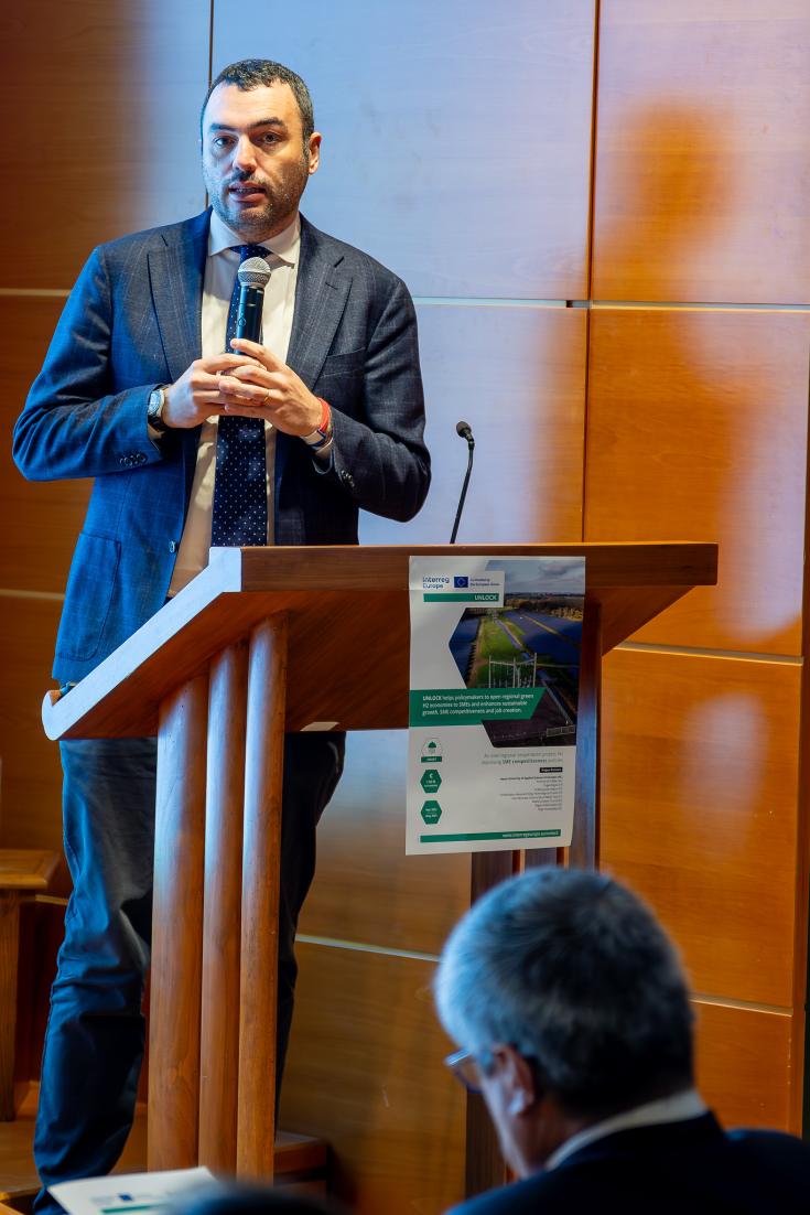 A man in business suit gives a talk