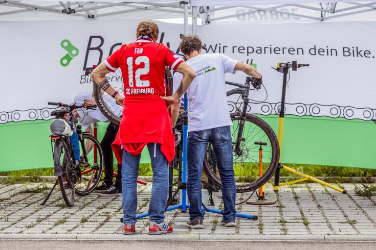 Two people fixing a bike