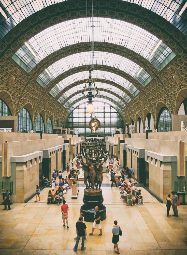 Brown and grey museum with people inside