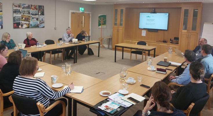 People sitting around a meeting room table