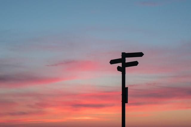 Direction pole post in sunset