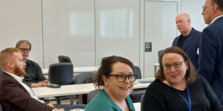 People chatting in a conference room