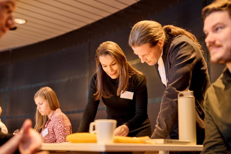 People looking at something on a table