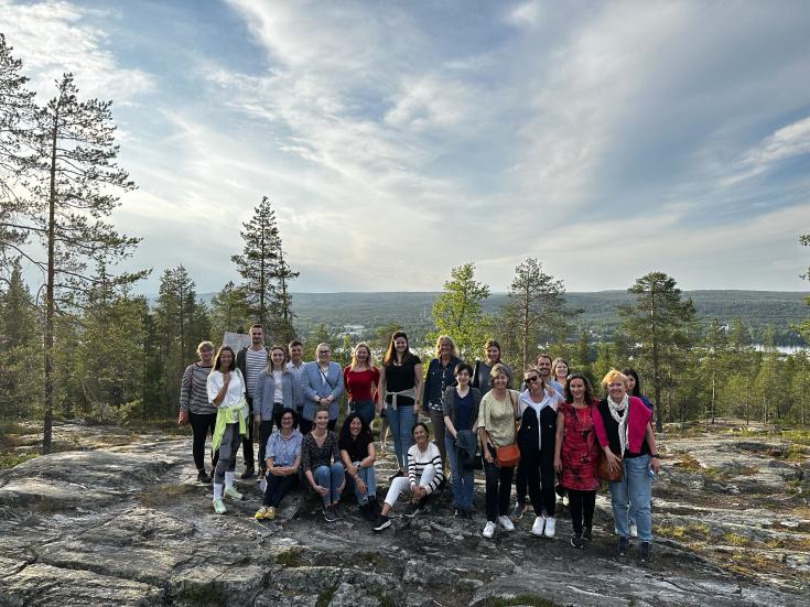 DEBUTING project group at Ounasvaara hill, Rovaniemi, Lapland. With midnight sun in the back.