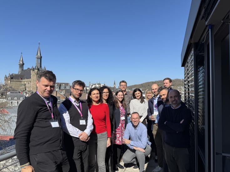 Project partners posing for a photo with Aachen cathedral in background.