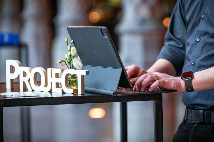 Person working on their computer Person typing on a computer