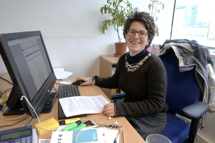 Interreg Youth Volunteer Pauline sitting at her desk with a computer