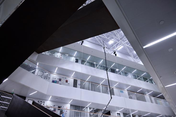 Inside of a building with several stories Inside of a building with several stories