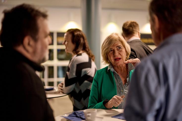 Older woman talking to two men Older woman talking to two men
