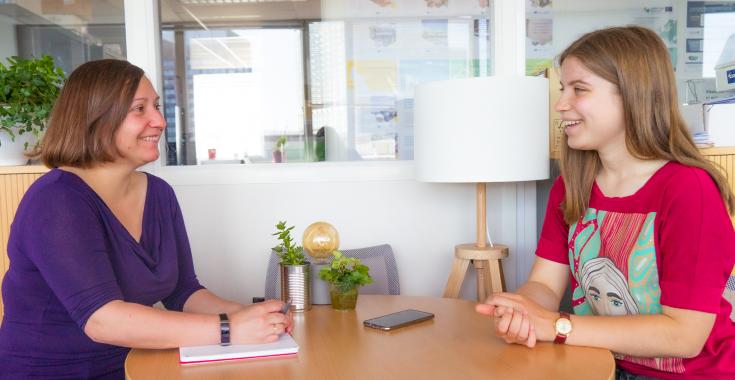 Staff member interviews youth volunteer about her experience at Interreg Europe.