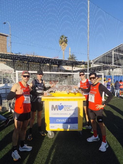 Runners having their photo taken around a waste container