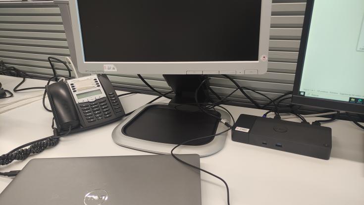 Picture of a desktop computer with a laptop charging on the table 