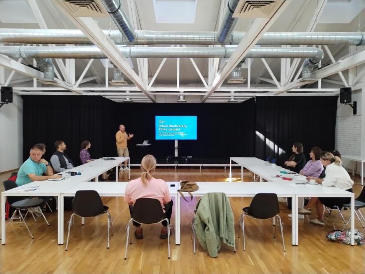 A meeting with one man in the front. 