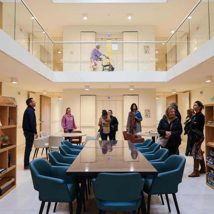 Partners below, elderly person walking on the top level in Residential Care Home