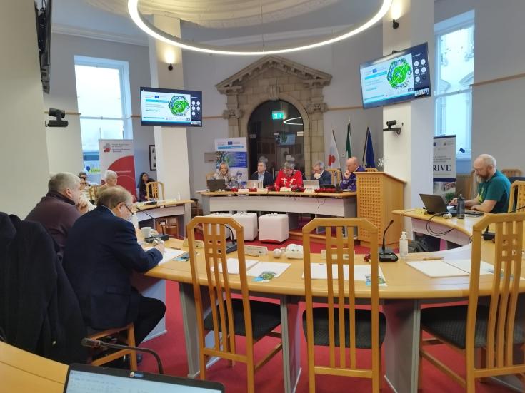 PROXIMITIES presented to Southern Regional Assembly Members Southern Regional Assembly members sitting in Assembly Chamber watching PROXIMITIES presentation