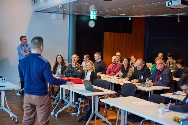People listening to person presenting People listening to person presenting