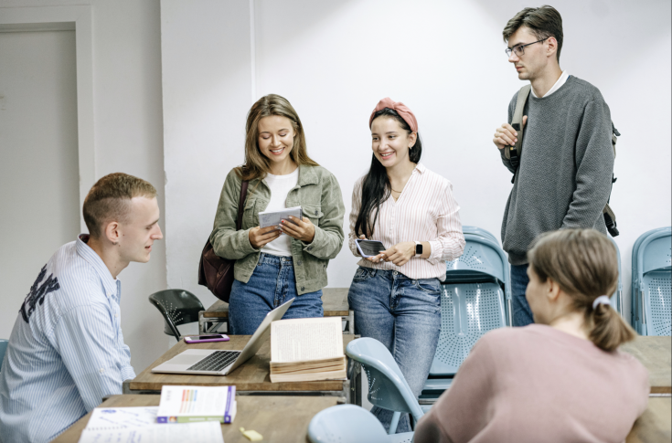 People sitting and standing around table