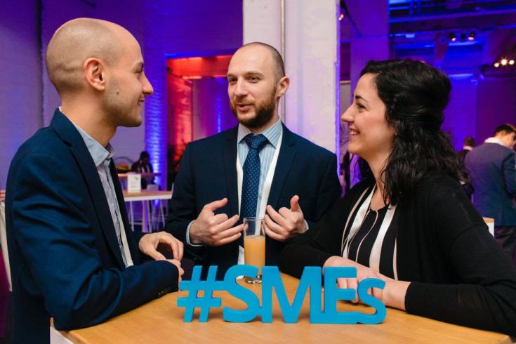 People speaking at a table with SME hashtag People speaking at a table with SME hashtag