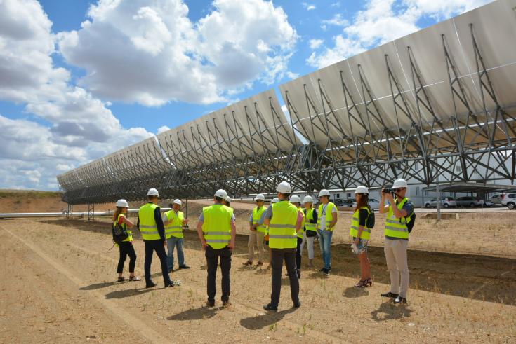 People talking behand Solar Panels