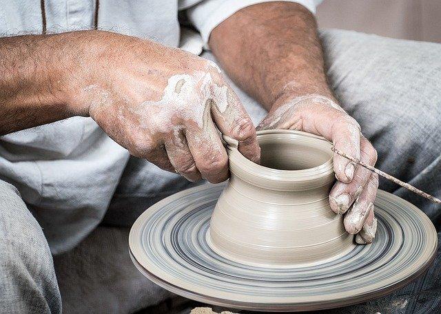 Person making clay pot