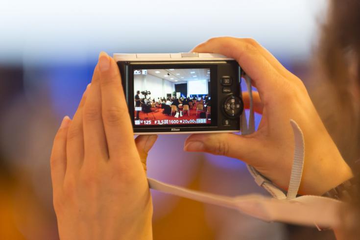 Person taking photo during event Person taking photo during event
