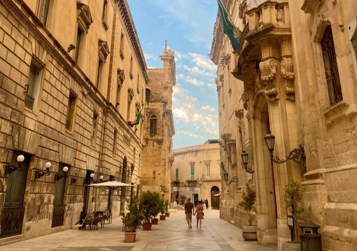 Two people walking in a baroque style street Two people walking in a baroque style street