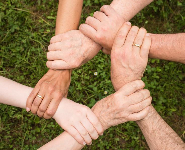 Six people holding each other's wrist