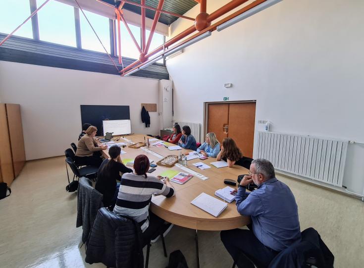 Slovenian first stakeholders' meeting A group of people is sitting behind the table discussing integration in Litija, Slovenia.