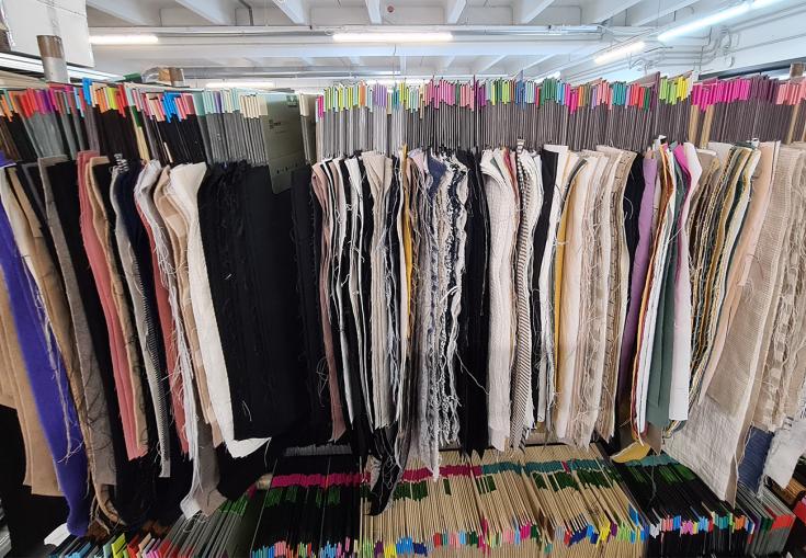 Many textile fabric samples hanging on a clothes haner