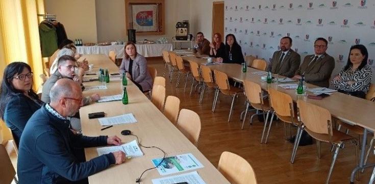 A group of persons in a meeting room