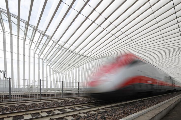 Train driving past in station at high speed