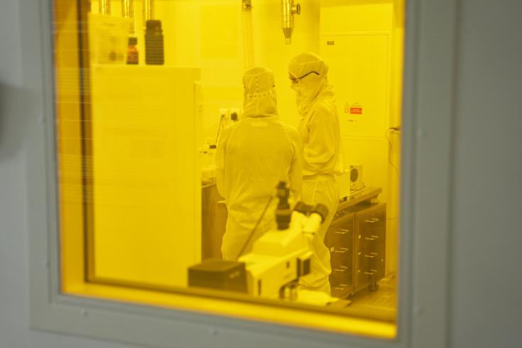 Two people standing in a lab Two people standing in a lab