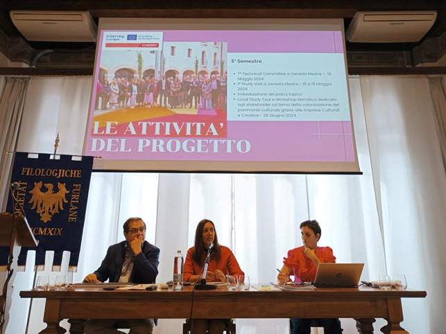 3 people at presentation table indoors