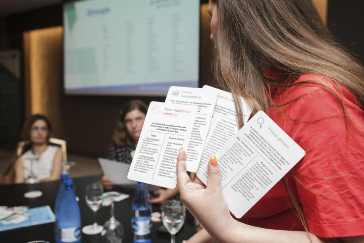 Woman holding up cards