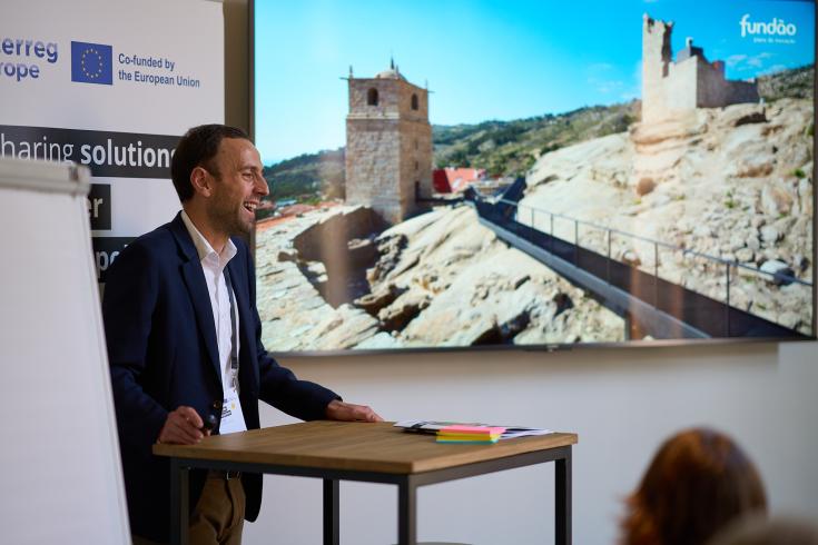 Man standing giving a presentation Man standing giving a presentation