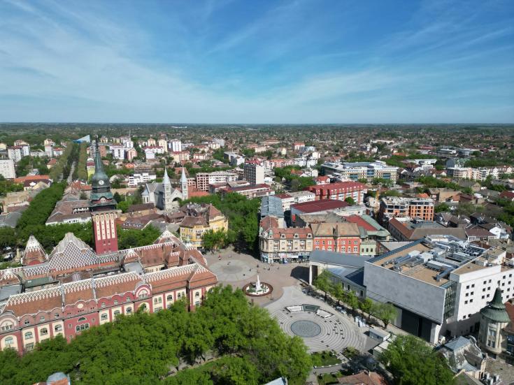 An aerial view of a city with tall buildings in Subotica, Serbia by Anton Lukin