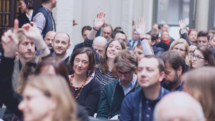 Event participants in a plenary hall audience